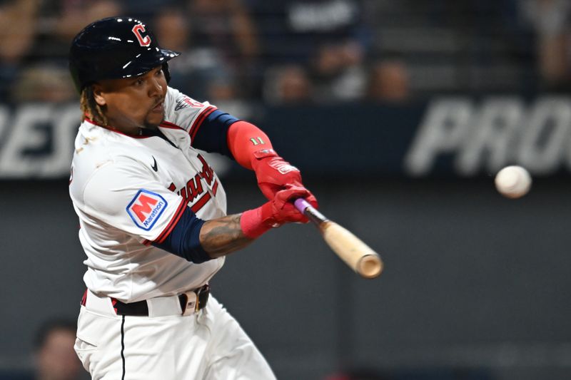 Sep 27, 2025; Cleveland, Ohio, USA; Cleveland Guardians third baseman Jose Ramirez (11) hits a single against the Texas Rangers during the first inning at Progressive Field. Mandatory Credit: Ken Blaze-Imagn Images
