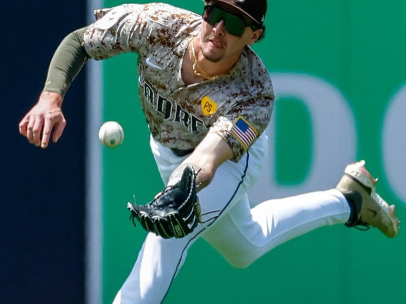 May 26, 2024; San Diego, California, USA; San Diego Padres center fielder Jackson Merrill (3) makes a diving catch in the fourth inning against the New York Yankees at Petco Park. Mandatory Credit: David Frerker-USA TODAY Sports