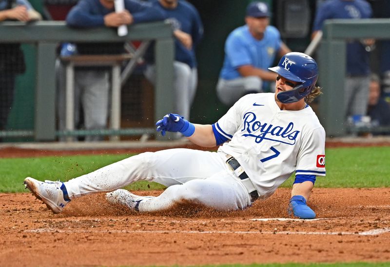 Jul 3, 2024; Kansas City, Missouri, USA;  Kansas City Royals shortstop Bobby Witt Jr. (7) slides home scoring a run in the third inning against the Tampa Bay Rays at Kauffman Stadium. Mandatory Credit: Peter Aiken-USA TODAY Sports