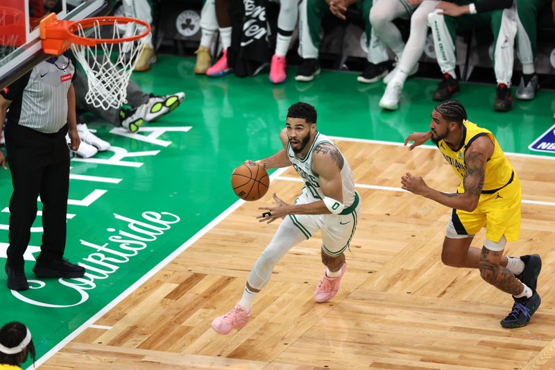 BOSTON, MASSACHUSETTS - MAY 21: Jayson Tatum #0 of the Boston Celtics drives to the basket against Obi Toppin #1 of the Indiana Pacers during the second quarter in Game One of the Eastern Conference Finals at TD Garden on May 21, 2024 in Boston, Massachusetts. NOTE TO USER: User expressly acknowledges and agrees that, by downloading and or using this photograph, User is consenting to the terms and conditions of the Getty Images License Agreement. (Photo by Adam Glanzman/Getty Images)