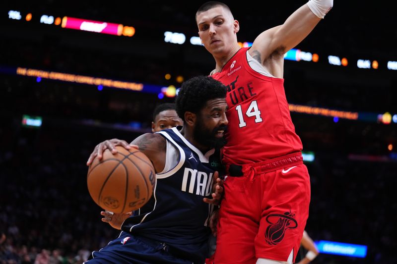 MIAMI, FLORIDA - NOVEMBER 24: Kyrie Irving #11 of the Dallas Mavericks dribbles the ball against Tyler Herro #14 of the Miami Heat during the second quarter at Kaseya Center on November 24, 2024 in Miami, Florida. NOTE TO USER: User expressly acknowledges and agrees that, by downloading and or using this photograph, User is consenting to the terms and conditions of the Getty Images License Agreement. (Photo by Rich Storry/Getty Images)