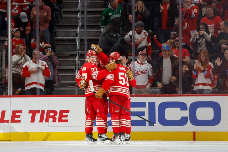Nov 9, 2025; Detroit, Michigan, USA; Detroit Red Wings defenseman Simon Edvinsson (77) and defenseman Moritz Seider (53) celebrate a goal scored by center Dylan Larkin (71) during the first period at Little Caesars Arena. Mandatory Credit: Brian Bradshaw Sevald-Imagn Images