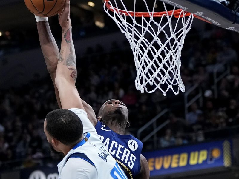 INDIANAPOLIS, INDIANA - MARCH 27: JaVale McGee #00 of the Dallas Mavericks blocks a dunk attempt by Aaron Nesmith #23 of the Indiana Pacers in the fourth quarter at Gainbridge Fieldhouse on March 27, 2023 in Indianapolis, Indiana. NOTE TO USER: User expressly acknowledges and agrees that, by downloading and or using this photograph, User is consenting to the terms and conditions of the Getty Images License Agreement. (Photo by Dylan Buell/Getty Images)