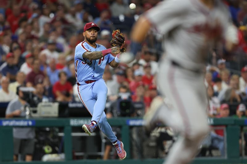 Aug 29, 2024; Philadelphia, Pennsylvania, USA; Philadelphia Phillies shortstop Edmundo Sosa (33) throws out Atlanta Braves outfielder Whit Merrifield (15) during the fifth inning at Citizens Bank Park. Mandatory Credit: Bill Streicher-USA TODAY Sports