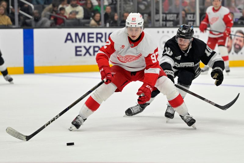 Nov 16, 2024; Los Angeles, California, USA; Detroit Red Wings center Marco Kasper (92) and Los Angeles Kings left wing Tanner Jeannot (10) race for the puck in the second period at Crypto.com Arena. Mandatory Credit: Jayne Kamin-Oncea-Imagn Images