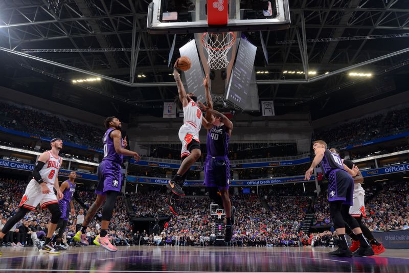 SACRAMENTO, CA - MARCH 4:  Coby White #0 of the Chicago Bulls drives to the basket during the game against the Sacramento Kings on March 4, 2024 at Golden 1 Center in Sacramento, California. NOTE TO USER: User expressly acknowledges and agrees that, by downloading and or using this Photograph, user is consenting to the terms and conditions of the Getty Images License Agreement. Mandatory Copyright Notice: Copyright 2024 NBAE (Photo by Rocky Widner/NBAE via Getty Images)