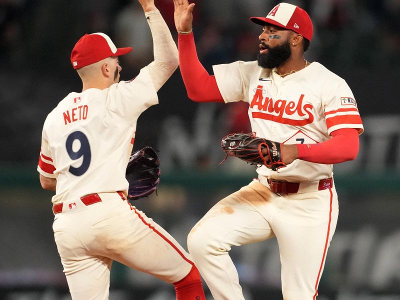 Jun 7, 2025; Anaheim, California, USA; Los Angeles Angels shortstop Zach Neto (9) and center fielder Jo Adell (7) celebrate at the end of the game against the Seattle Mariners at Angel Stadium. Mandatory Credit: Kirby Lee-Imagn Images
