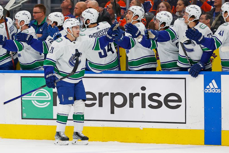 Oct 14, 2023; Edmonton, Alberta, CAN; The Vancouver Canucks celebrate a goal by forward Nils Hoglander (21) during the first period against the Edmonton Oilers at Rogers Place. Mandatory Credit: Perry Nelson-USA TODAY Sports