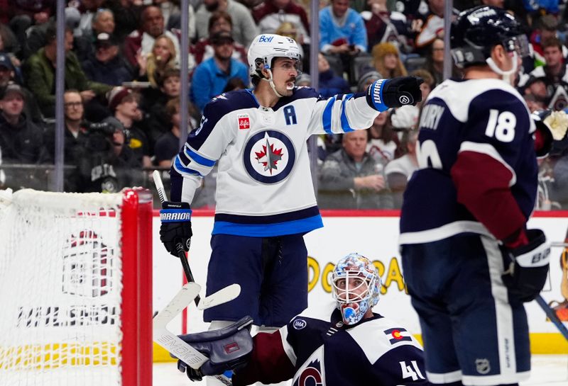 Dec 19, 2025; Denver, Colorado, USA; Winnipeg Jets center Mark Scheifele (55) celebrates his goal on Colorado Avalanche goaltender Scott Wedgewood (41) in the third period at Ball Arena. Mandatory Credit: Ron Chenoy-Imagn Images