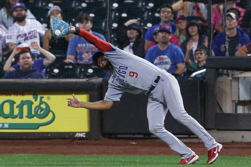 Aug 7, 2023; New York City, New York, USA; Chicago Cubs third baseman Jeimer Candelario (9) catches a ball hit by New York Mets third baseman Mark Vientos (not pictured) to end the fifth inning at Citi Field. Mandatory Credit: Vincent Carchietta-USA TODAY Sports