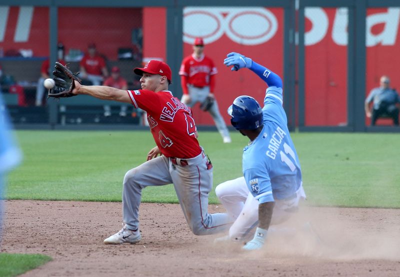 Jun 17, 2023; Kansas City, Missouri, USA; Kansas City Royals third baseman Maikel Garcia (11) slides safely into second base as Los Angeles Angels shortstop Andrew Valezquez (4) is late with the tag in the ninth inning at Kauffman Stadium. Mandatory Credit: Scott Sewell-USA TODAY Sports