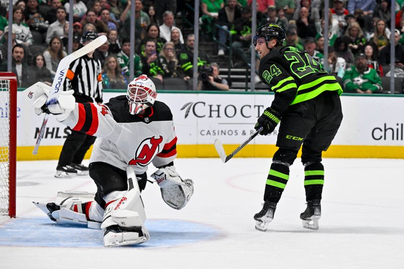 Mar 14, 2024; Dallas, Texas, USA; New Jersey Devils goaltender Jake Allen (34) turns aside a shot by Dallas Stars center Roope Hintz (24) during the second period at the American Airlines Center. Mandatory Credit: Jerome Miron-USA TODAY Sports