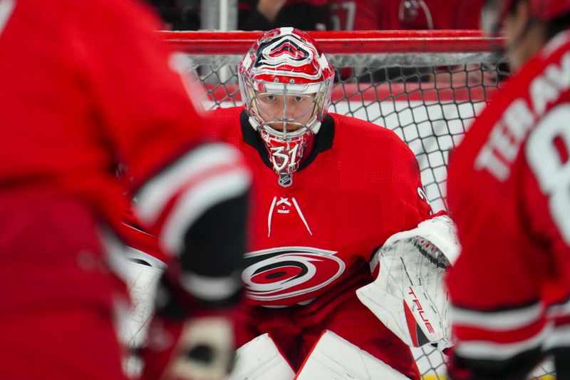 Oct 26, 2023; Raleigh, North Carolina, USA; Carolina Hurricanes goaltender Frederik Andersen (31) watches the shot in the warmups before the game against the Seattle Kraken at PNC Arena. Mandatory Credit: James Guillory-USA TODAY Sports