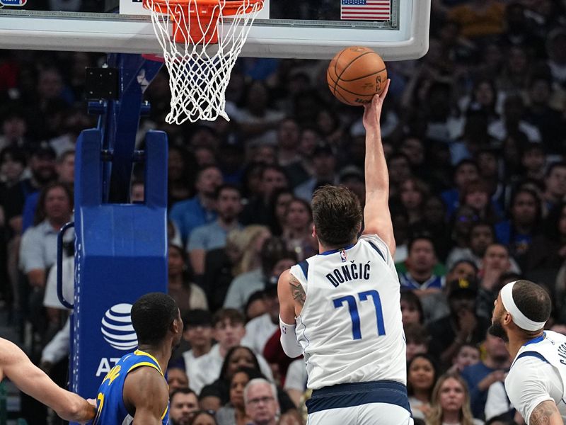 DALLAS, TX - MARCH 13: Luka Doncic #77 of the Dallas Mavericks drives to the basket during the game against the Golden State Warriors on March 13, 2024 at the American Airlines Center in Dallas, Texas. NOTE TO USER: User expressly acknowledges and agrees that, by downloading and or using this photograph, User is consenting to the terms and conditions of the Getty Images License Agreement. Mandatory Copyright Notice: Copyright 2024 NBAE (Photo by Glenn James/NBAE via Getty Images)