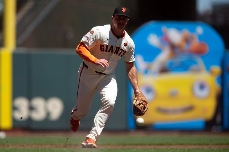 Aug 15, 2024; San Francisco, California, USA; San Francisco Giants third baseman Matt Chapman (26) charges a ground ball by Atlanta Braves shortstop Orlando Arcia (not pictured) during the second inning at Oracle Park. Mandatory Credit: D. Ross Cameron-USA TODAY Sports
