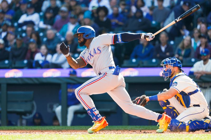 Oct 1, 2023; Seattle, Washington, USA; Texas Rangers right fielder Adolis Garcia (53) hits a single against the Seattle Mariners during the fourth inning at T-Mobile Park. Mandatory Credit: Joe Nicholson-USA TODAY Sports