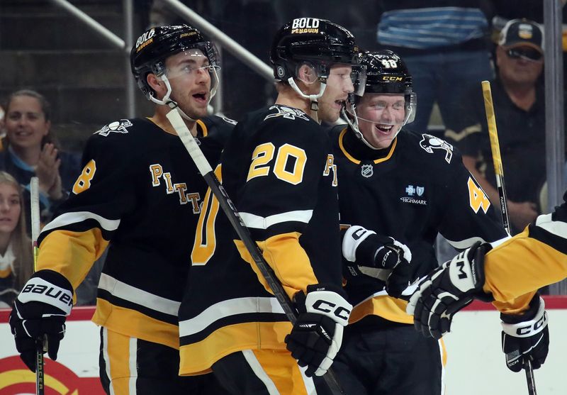 Oct 29, 2024; Pittsburgh, Pennsylvania, USA; Pittsburgh Penguins right wing Valtteri Puustinen (right) celebrates his goal with left wing Michael Bunting (8) and center Lars Eller (20) against the Minnesota Wild during the first period at PPG Paints Arena. Mandatory Credit: Charles LeClaire-Imagn Images