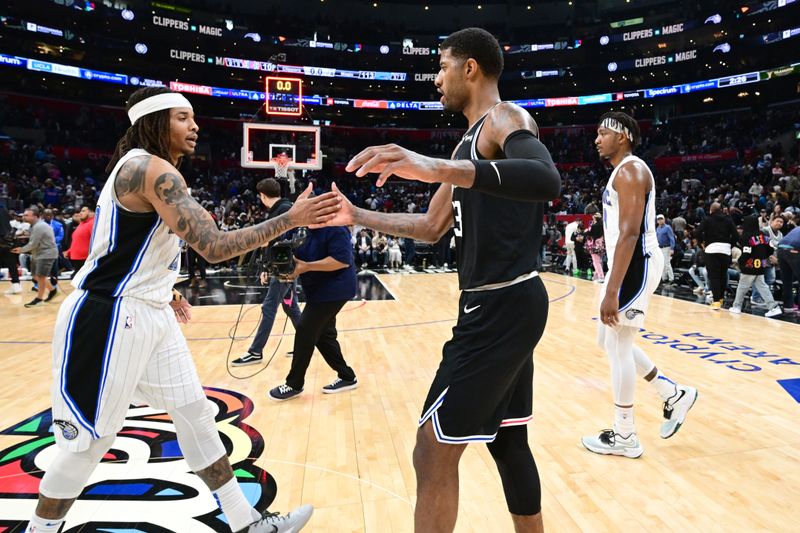 LOS ANGELES, CA - MARCH 18: Markelle Fultz #20 of the Orlando Magic high fives Paul George #13 of the LA Clippers after the game on March 18, 2023 at Crypto.Com Arena in Los Angeles, California. NOTE TO USER: User expressly acknowledges and agrees that, by downloading and/or using this Photograph, user is consenting to the terms and conditions of the Getty Images License Agreement. Mandatory Copyright Notice: Copyright 2023 NBAE (Photo by Adam Pantozzi/NBAE via Getty Images)