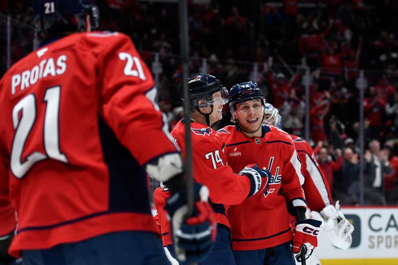 Feb 2, 2026; Washington, District of Columbia, USA; Washington Capitals defenseman John Carlson (74) celebrates with defenseman Martin Fehervary (42) after scoring an empty net goal against the New York Islanders during the third period at Capital One Arena. Mandatory Credit: Hannah Foslien-Imagn Images