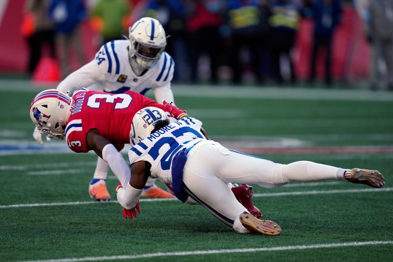 Indianapolis Colts cornerback Kenny Moore II (23) tackles New England Patriots wide receiver DeMario Douglas (3) during the first half of an NFL football game, Sunday, Dec. 1, 2024, in Foxborough, Mass. (AP Photo/Charles Krupa)