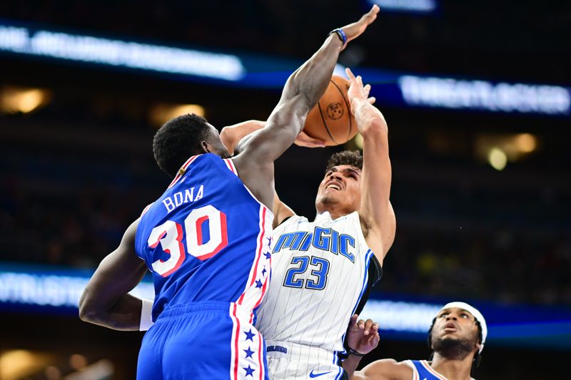 ORLANDO, FLORIDA - OCTOBER 18: Adem Bona #30 of the Philadelphia 76ers blocks a shot from Tristan da Silva #23 of the Orlando Magic in the second half of a game at Kia Center on October 18, 2024 in Orlando, Florida. NOTE TO USER: User expressly acknowledges and agrees that, by downloading and or using this photograph, User is consenting to the terms and conditions of the Getty Images License Agreement. (Photo by Julio Aguilar/Getty Images)