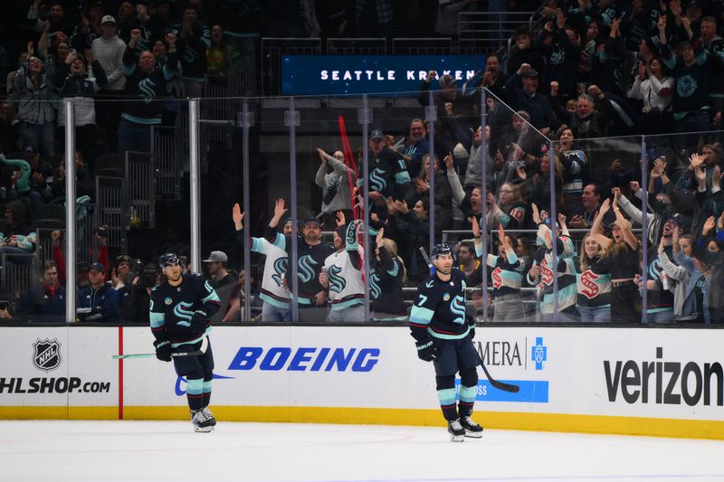 Feb 22, 2024; Seattle, Washington, USA; Seattle Kraken center Matty Beniers (10) and right wing Jordan Eberle (7) celebrate after Eberle scored a goal against the Vancouver Canucks during the third period at Climate Pledge Arena. Mandatory Credit: Steven Bisig-USA TODAY Sports