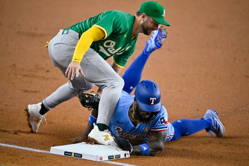 Sep 1, 2024; Arlington, Texas, USA; Oakland Athletics third baseman Max Schuemann (12) tags out Texas Rangers right fielder Adolis Garcia (53) on a steal attempt by Garcia during the first inning at Globe Life Field. Mandatory Credit: Jerome Miron-USA TODAY Sports