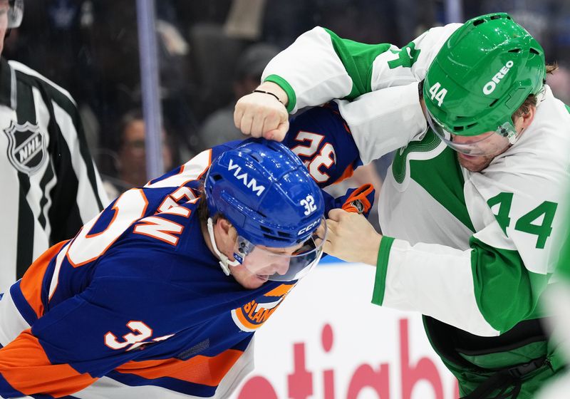 Mar 17, 2026; Toronto, Ontario, CAN; Toronto Maple Leafs defenseman Morgan Rielly (44) fights with New York Islanders center Kyle MacLean (32) during the second period at Scotiabank Arena. Mandatory Credit: Nick Turchiaro-Imagn Images