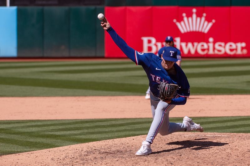 May 7, 2024; Oakland, California, USA; Texas Rangers pitcher Cole Winn (60) throws a pitch during the ninth inning against the Oakland Athletics at Oakland-Alameda County Coliseum. Mandatory Credit: Ed Szczepanski-USA TODAY Sports