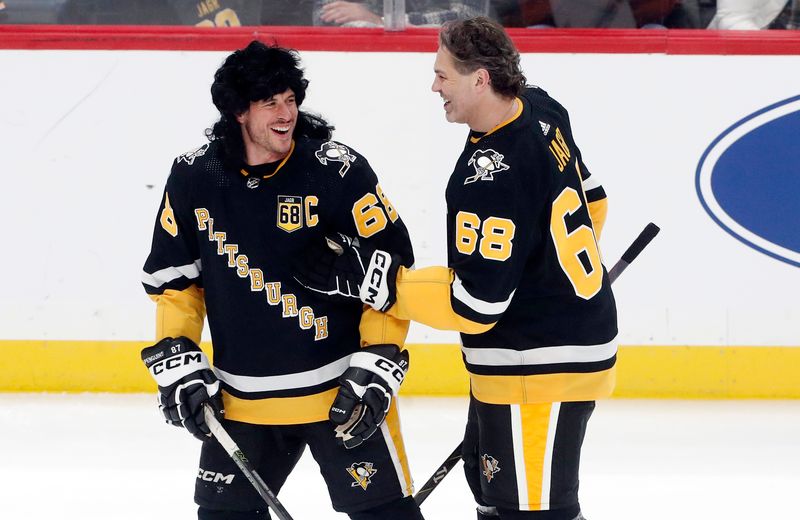 Feb 18, 2024; Pittsburgh, Pennsylvania, USA;  Pittsburgh Penguins center Sidney Crosby (left) laughs with former right wing Jaromir Jagr (68 right) before the game against the Los Angeles Kings at PPG Paints Arena. Mandatory Credit: Charles LeClaire-USA TODAY Sports