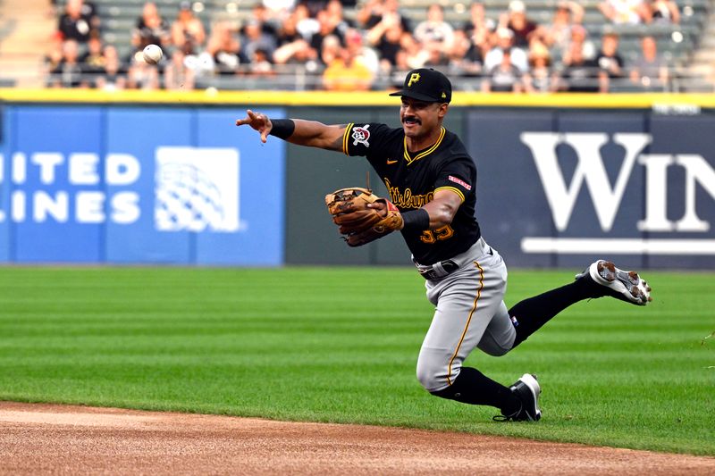 Jul 12, 2024; Chicago, Illinois, USA;   Pittsburgh Pirates second baseman  Nick Gonzales (39) trips while throwing to first base during the first inning at Guaranteed Rate Field. Mandatory Credit: Matt Marton-USA TODAY Sports