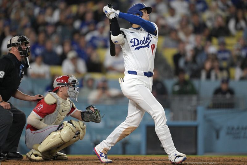 May 16, 2025; Los Angeles, California, USA;  Los Angeles Dodgers designated hitter Shohei Ohtani (17) hits a solo home run in the seventh inning against the Los Angeles Angels at Dodger Stadium. Mandatory Credit: Jayne Kamin-Oncea-Imagn Images