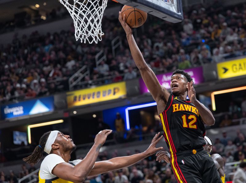 INDIANAPOLIS, INDIANA - APRIL 14: De'Andre Hunter #12 of the Atlanta Hawks shoots the ball against Myles Turner #33 of the Indiana Pacers during the first half at Gainbridge Fieldhouse on April 14, 2024 in Indianapolis, Indiana. NOTE TO USER: User expressly acknowledges and agrees that, by downloading and or using this photograph, User is consenting to the terms and conditions of the Getty Images License Agreement. (Photo by Michael Hickey/Getty Images)