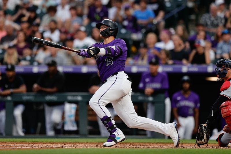 Jun 21, 2024; Denver, Colorado, USA; Colorado Rockies designated hitter Hunter Goodman (15) watches his ball on a two run home run in the fourth inning against the Washington Nationals at Coors Field. Mandatory Credit: Isaiah J. Downing-USA TODAY Sports