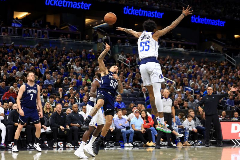 ORLANDO, FLORIDA - NOVEMBER 06: Cole Anthony #50 of the Orlando Magic tries to shoot over Derrick Jones Jr. #55 of the Dallas Mavericks during a game  at Amway Center on November 06, 2023 in Orlando, Florida. (Photo by Mike Ehrmann/Getty Images) NOTE TO USER: User expressly acknowledges and agrees that, by downloading and or using this photograph, User is consenting to the terms and conditions of the Getty Images License Agreement. (Photo by Mike Ehrmann/Getty Images)