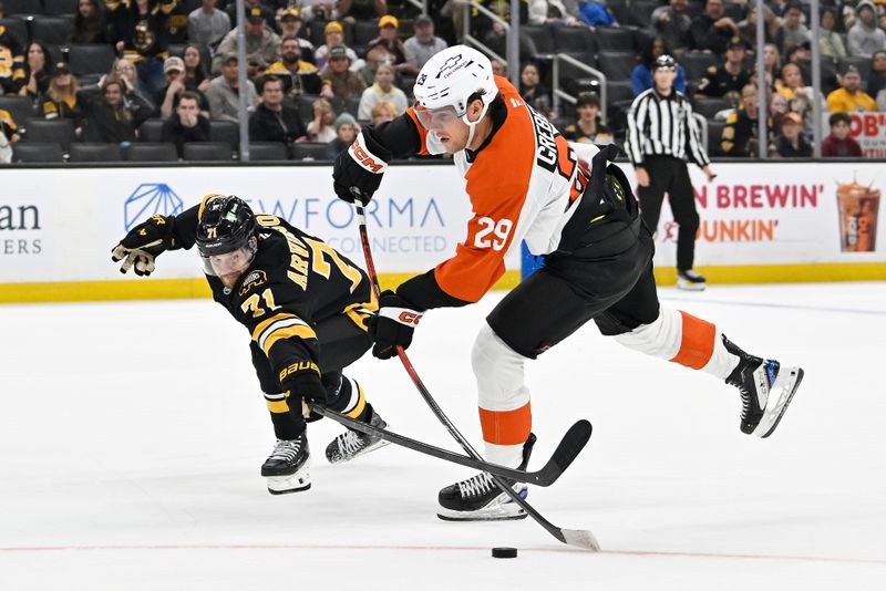 Sep 29, 2025; Boston, Massachusetts, USA;  Boston Bruins left wing Viktor Arvidsson (71) checks the stick of Philadelphia Flyers forward Nikita Grebenkin (29) as he takes a shot during overtime at TD Garden. Mandatory Credit: Eric Canha-Imagn Images