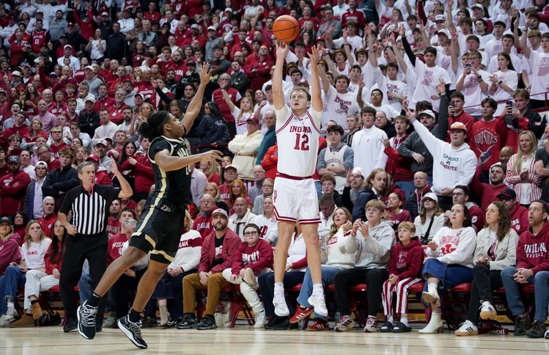 Jan 27, 2026; Bloomington, Indiana, USA; Indiana Hoosiers forward Tucker DeVries (12) shoots the ball over Purdue Boilermakers guard Gicarri Harris (24) during the first half at Simon Skjodt Assembly Hall. Mandatory Credit: Robert Goddin-Imagn Images