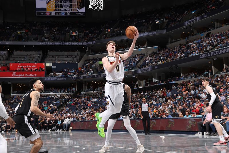 MEMPHIS, TN - APRIL 14:  Christian Braun #0 of the Denver Nuggets drives to the basket during the game against the Memphis Grizzlies on April 14, 2024 at FedExForum in Memphis, Tennessee. NOTE TO USER: User expressly acknowledges and agrees that, by downloading and or using this photograph, User is consenting to the terms and conditions of the Getty Images License Agreement. Mandatory Copyright Notice: Copyright 2024 NBAE (Photo by Joe Murphy/NBAE via Getty Images)