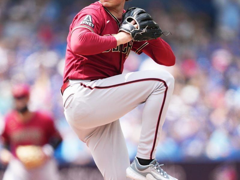 Jul 16, 2023; Toronto, Ontario, CAN; Arizona Diamondbacks starting pitcher Tommy Henry (47) throws pitch against the Toronto Blue Jays during the first inning at Rogers Centre. Mandatory Credit: Nick Turchiaro-USA TODAY Sports