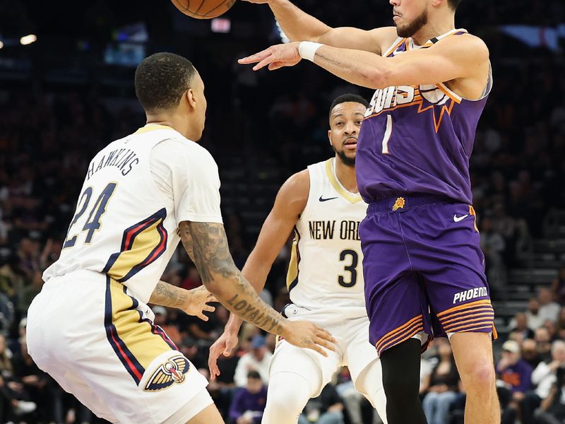 PHOENIX, ARIZONA - FEBRUARY 27: Devin Booker #1 of the Phoenix Suns passes the ball over Jordan Hawkins #24 of the New Orleans Pelicans during the first half of the NBA game at Footprint Center on February 27, 2025 in Phoenix, Arizona. NOTE TO USER: User expressly acknowledges and agrees that, by downloading and or using this photograph, User is consenting to the terms and conditions of the Getty Images License Agreement.  (Photo by Christian Petersen/Getty Images)