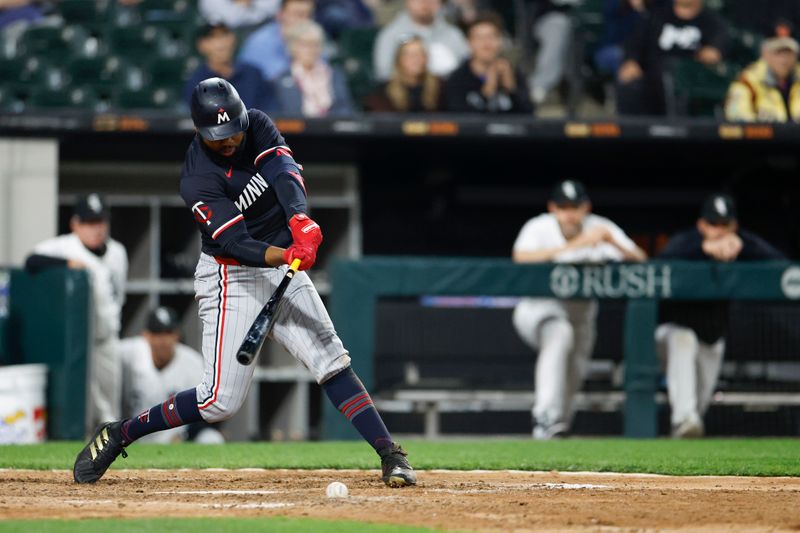 Apr 30, 2024; Chicago, Illinois, USA; Minnesota Twins outfielder Manuel Margot (13) singles against the Chicago White Sox during the ninth inning at Guaranteed Rate Field. Mandatory Credit: Kamil Krzaczynski-USA TODAY Sports