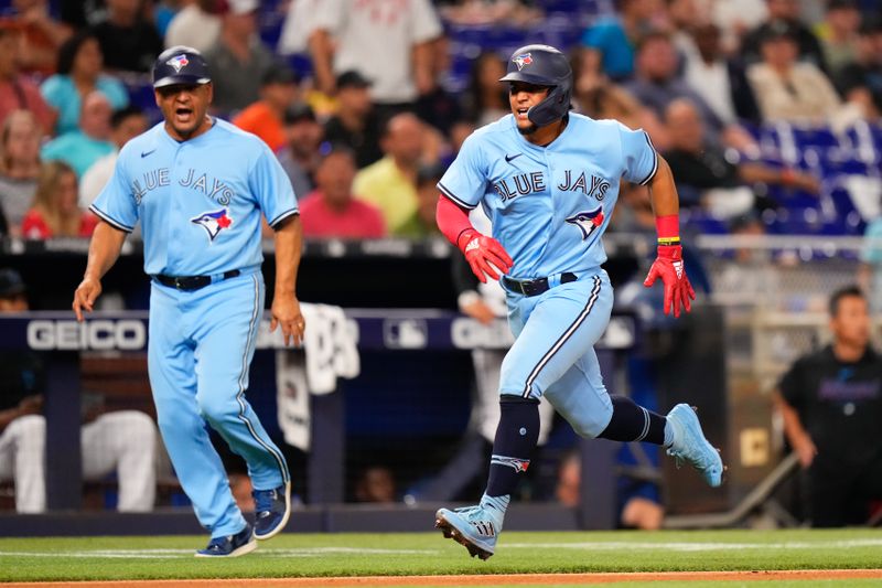 Jun 20, 2023; Miami, Florida, USA; Toronto Blue Jays second baseman Santiago Espinal (5) runs into home base against the Miami Marlins during the eighth inning at loanDepot Park. Mandatory Credit: Rich Storry-USA TODAY Sports