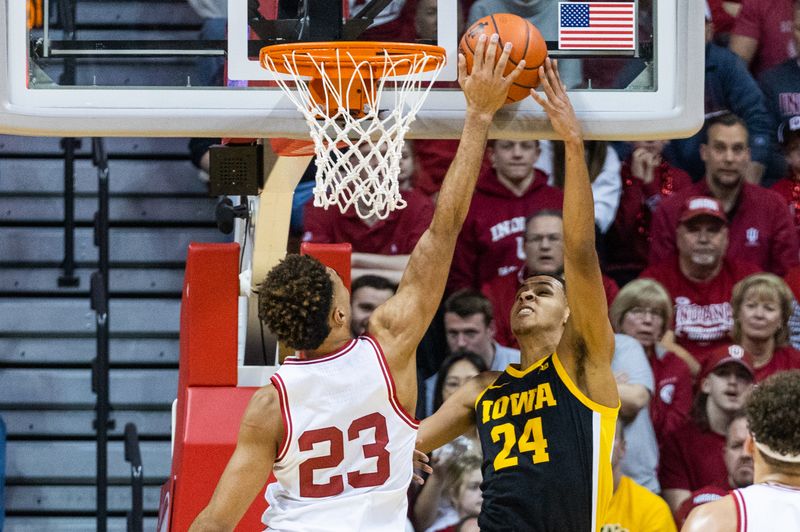 Feb 28, 2023; Bloomington, Indiana, USA; Indiana Hoosiers forward Trayce Jackson-Davis (23) blocks the shot of Iowa Hawkeyes forward Kris Murray (24) in the first half at Simon Skjodt Assembly Hall. Mandatory Credit: Trevor Ruszkowski-USA TODAY Sports