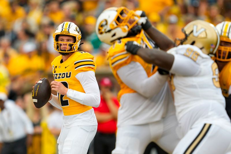 Sep 21, 2024; Columbia, Missouri, USA; Missouri Tigers quarterback Brady Cook (12) drops back to pass during the first half against the Vanderbilt Commodores at Faurot Field at Memorial Stadium. Mandatory Credit: Jay Biggerstaff-Imagn Images