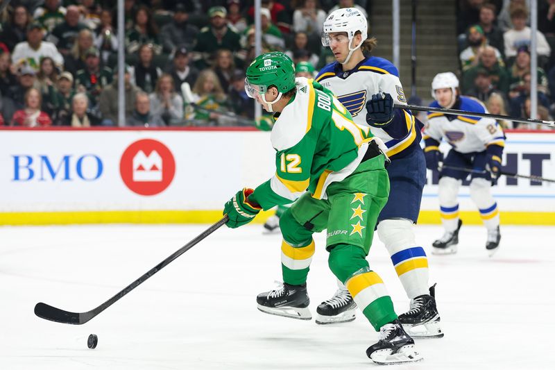 Mar 23, 2024; Saint Paul, Minnesota, USA; Minnesota Wild left wing Matt Boldy (12) skates with the puck against the St. Louis Blues during the first period at Xcel Energy Center. Mandatory Credit: Matt Krohn-USA TODAY Sports