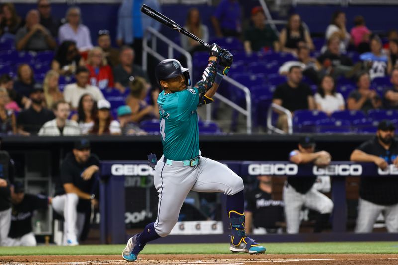 Jun 21, 2024; Miami, Florida, USA; Seattle Mariners center fielder Julio Rodriguez (44) hits an RBI single against the Miami Marlins during the first inning at loanDepot Park. Mandatory Credit: Sam Navarro-USA TODAY Sports