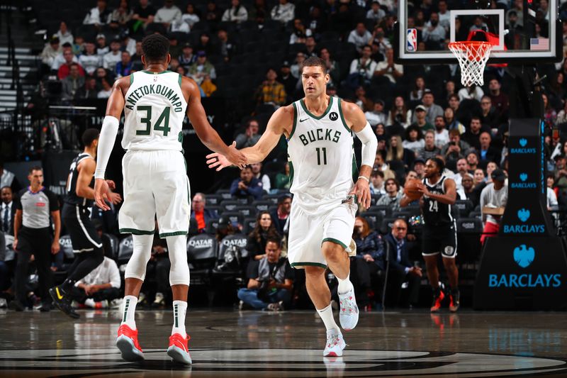 BROOKLYN, NY - OCTOBER 27: Giannis Antetokounmpo #34 and Brook Lopez #11 of the Milwaukee Bucks high five during the game against the Brooklyn Nets on October 27, 2024 at Barclays Center in Brooklyn, New York. NOTE TO USER: User expressly acknowledges and agrees that, by downloading and or using this Photograph, user is consenting to the terms and conditions of the Getty Images License Agreement. Mandatory Copyright Notice: Copyright 2024 NBAE (Photo by David L. Nemec/NBAE via Getty Images)