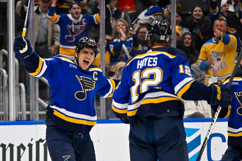 Nov 30, 2023; St. Louis, Missouri, USA;  St. Louis Blues right wing Kevin Hayes (12) is congratulated by center Brayden Schenn (10) after scoring against the Buffalo Sabres during the second period at Enterprise Center. Mandatory Credit: Jeff Curry-USA TODAY Sports