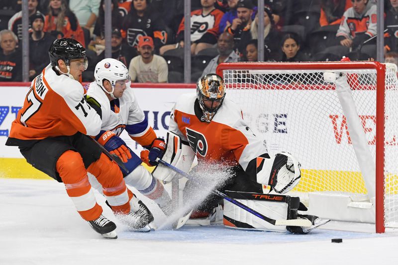 Sep 26, 2024; Philadelphia, Pennsylvania, USA; New York Islanders right wing Julien Gauthier (16) drives the goal against Philadelphia Flyers defenseman Erik Johnson (77) and goaltender Samuel Ersson (33) during the third period at Wells Fargo Center. Mandatory Credit: Eric Hartline-Imagn Images