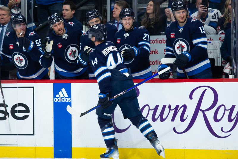 Jan 9, 2024; Winnipeg, Manitoba, CAN; Winnipeg Jets defenseman Josh Morrissey (44) is congratulated by his teammates on his goal against the Columbus Blue Jackets during the second period at Canada Life Centre. Mandatory Credit: Terrence Lee-USA TODAY Sports